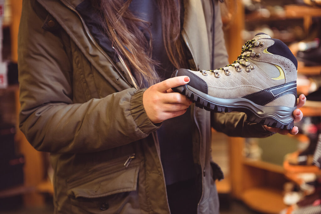 Close-up of woman selecting shoe in a shop